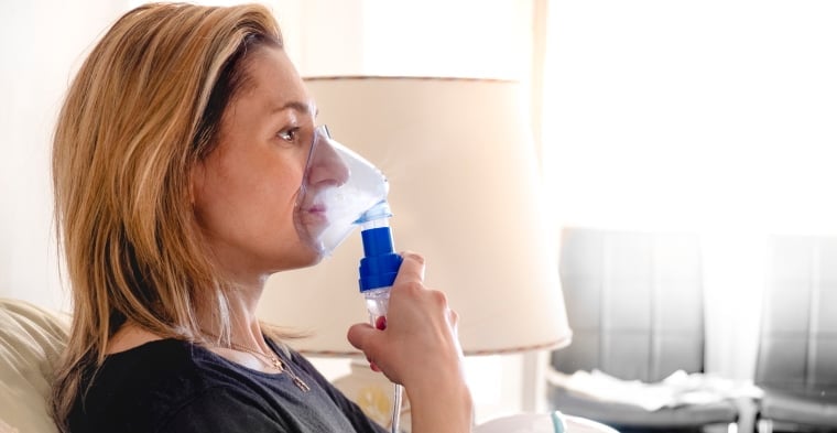 woman using a nebuliser