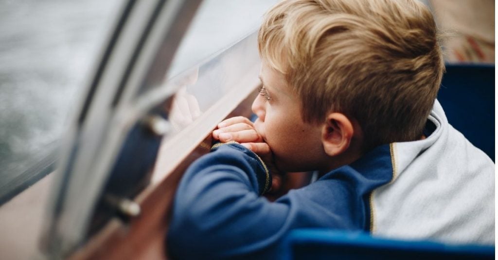 boy gazes out a window